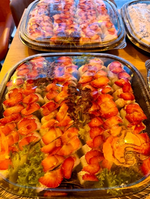 Two aluminum trays of diced red and yellow peppers with onions