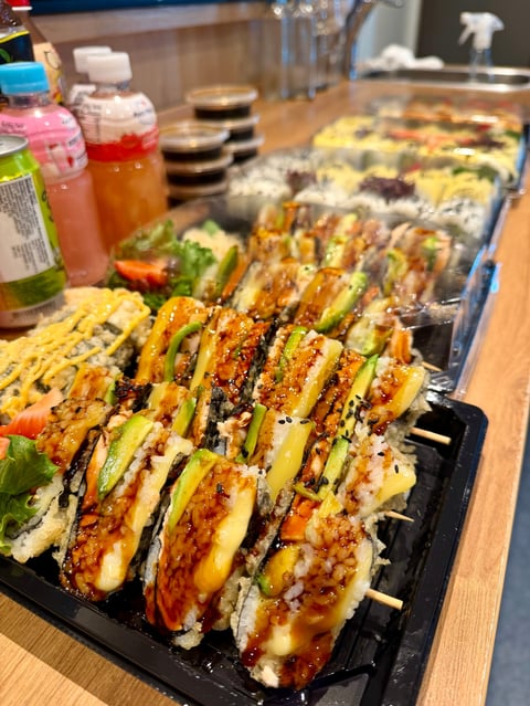 Platter of grilled corn on wooden skewers with caramelized kernels and sauce